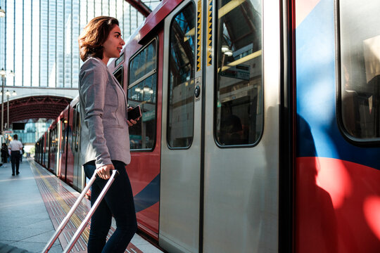 Woman commuting on train station platform travelling