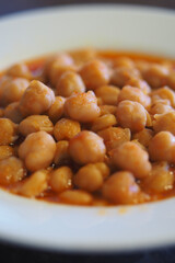 Chickpeas in spicy sauce served in a white bowl