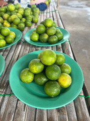 lime on green dish in market