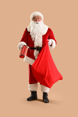 Shocked Santa Claus with Christmas bag and dynamite on beige background dynamite