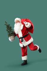 Santa Claus with bag and Christmas tree running on green background