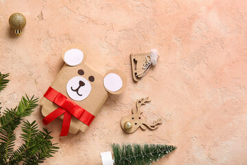 Beautiful composition with present box, fir branch and Christmas toys on pink grunge background
