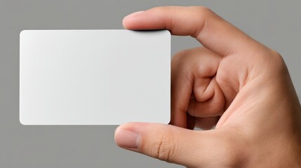 Obraz premium Shows hand presenting blank white business card perfect for customizable professional needs.