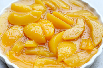 Sliced peaches in syrup served in a bowl