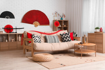 Interior of living room with sofa, table and decor for Japanese New Year celebration