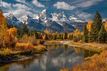 Obraz premium A majestic mountain peak with snow covered in bright blue sky surrounded by golden autumn trees and lake in the foreground