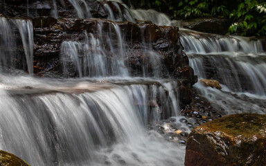 A waterfall cascading down from layers of rock