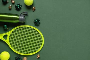Tennis equipment with Christmas balls on green background