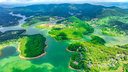 Aerial view of Tuyen Lam lake in Dalat, Vietnam with blue water and paradise islands below give this place a relaxing tourist attraction. This is a hydroelectric lake that provides energy for highland