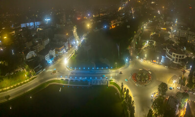 Aerial view of a Da Lat City, Vietnam in the mist magical night, hiden in the fog and clouds. Urban development texture, transport infrastructure. Tourist city in developed Vietnam.