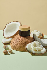 Half coconuts with chunks of shea butter styled neatly on pastel background, photographed for clean natural beauty concepts, spa, and skincare promotional visuals. Mockup cosmetic jar for design