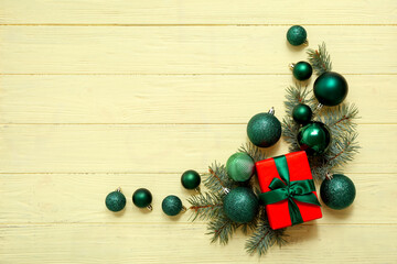 Christmas gift boxes with fir tree branches and gift box on beige wooden background