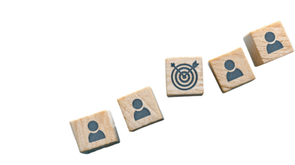 Wooden blocks with person icons, one with a target