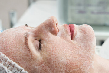 Naklejka premium Young pretty woman receiving treatments in beauty salons. Using facial cleansing foam