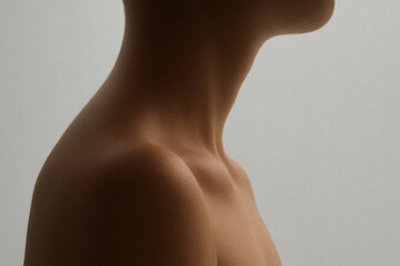 Close up of human neck and shoulder, showcasing smooth skin and elegant contours. soft lighting highlights natural beauty and form, creating serene and artistic composition