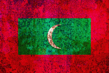 An abstract grunge-textured image showcases a weathered flag with red and green hues and a central...