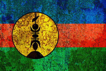 Distressed and textured background showcases the New Caledonia flag with its vibrant colors and the...
