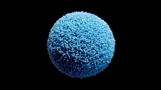 A vibrant, light-blue sphere, densely packed with small spheres, stands out against a deep black backdrop.