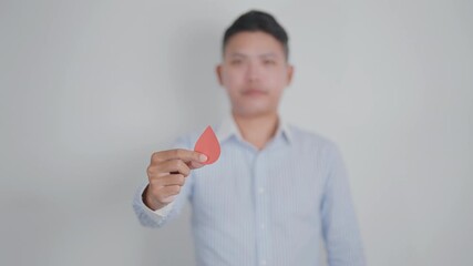 man in blue shirt with red Blood drop for World Diabetes Day, Blue November Health month, Diabetes awareness, Blood sugar check, Insulin, Glucose screening, blood donoo and Health checkup