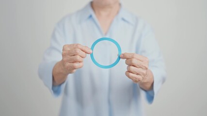 Elderly woman with Blue Circle for World Diabetes Day, Blue November Health month, Diabetes awareness, Blood sugar check, Insulin, Glucose screening, Healthy lifestyle, Chronic disease checkup