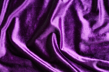 Crumpled violet velvet as background, closeup
