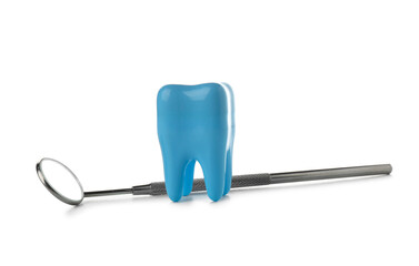 Decorative plastic tooth and dental mirror isolated on white background