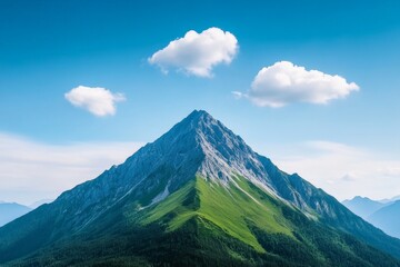 Fototapeta premium Majestic mountain peak under clear blue sky with fluffy clouds in stunning landscape
