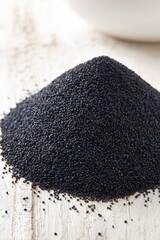 Pile Of Black Seeds On White Wooden Surface