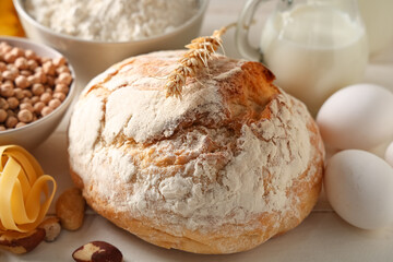 Different products on white wooden table, closeup. Food Allergy Awareness Month