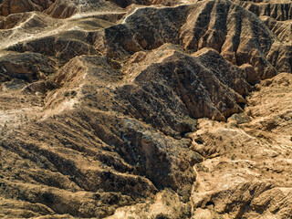 Flat lay photo of sandy crater-like formations in the Lunar Canyon, part of Charyn Canyon, taken from above.