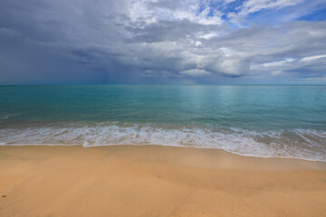 Beach with a cloudy sky in the background