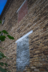 Fragment of an old brick wall on an autumn day