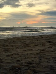 Dramatic Cloudy Sunrise Over the Wavy Ocean