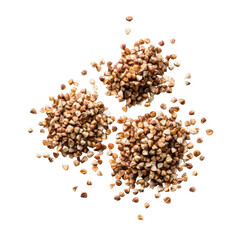 Three clusters of buckwheat groats, scattered on transparent background