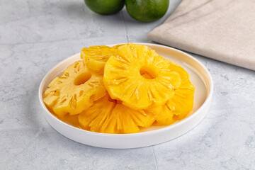 Sweet canned pineapple slices in syrope