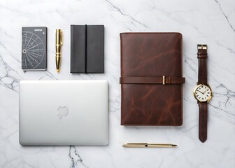 Flat lay of a modern workspace with a laptop journal and watch