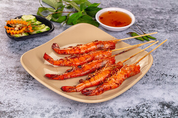 Grilled prawn skewer served sauce