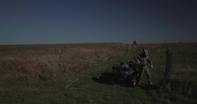 drone footage hunter driving four wheeler ATV and checking camera