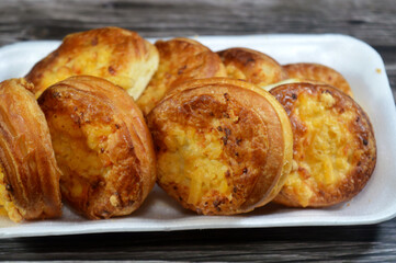 Rumi cheese toppings Pizzette Pizzetta mini Pizza, a small pizza topped and filled with Egyptian Roumi middle Eastern parmesan hard cheese, baked in the oven and served as a snack