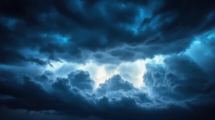 Obraz premium Dramatic dark storm clouds gathering in the sky with bright light breaking through creating a powerful and intense atmosphere