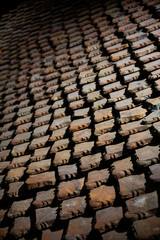 Obraz premium A roof covered with numerous overlapping, weathered clay tiles