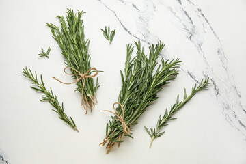 Bunches of fresh rosemary on marble background