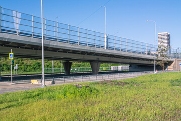 Noise barrier on the ring road. Construction of high-speed highways.  A road junction. A road bridge on reinforced concrete pillars.