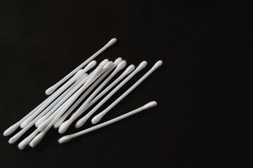 Cotton buds for health purposes. Taken on a black background.