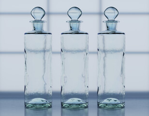 3 Old Victorian Perfume or medicine bottle in clear glass on a window sill against frosted glass window - Apothecary or drug store	