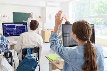 Female student studying at school computer lab, back view