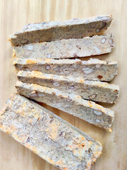 Close-Up of Unique Indonesian Oncom Snack Slices Showcasing Nuts and Fermented Texture