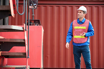 Worker or engineer is inspecting a forklift at the container yard