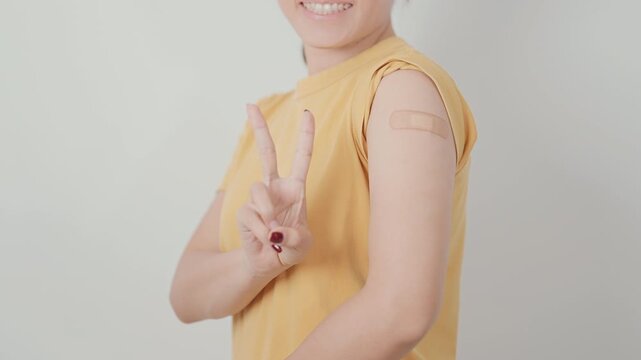 Adult Woman with bandage after received vaccine. Vaccination and Immunization for Influenza, HPV, Zoster, IPD, DTP or Diphtheria, Tetanus and Pertussis, MMR, Hepatitis B, Covid and Varicella vaccine
