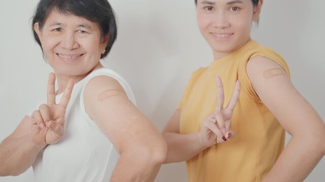 Adult and Elderly Woman with bandage after received vaccine. Vaccination and Immunization for Influenza, HPV, Zoster, IPD, DTP, Dengue, Encephalitis, Rabies, Pneumococcal Hepatitis B and Covid vaccine